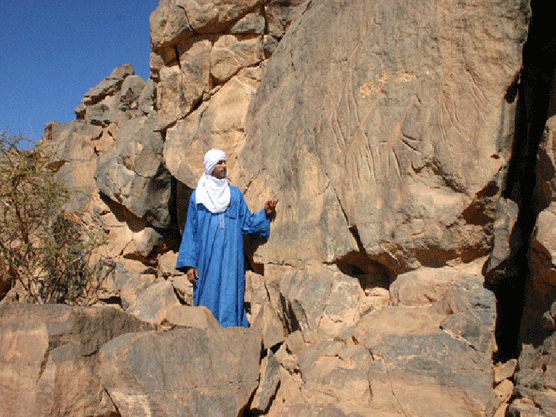 Un tuareg mostra le incisioni rupestri del Metandush. Pioniere, Fabrizio Mori con le sue scoperte ha rivoluzionato le scienze antropologiche